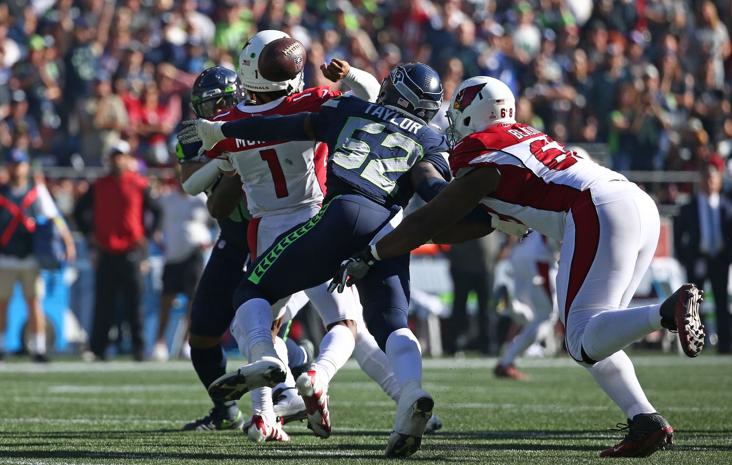 SEATTLE, WASHINGTON - OCTOBER 16: Darrell Taylor #52 of the Seattle Seahawks forces a fumble against Kyler Murray #1 of the Arizona Cardinals during the second quarter at Lumen Field on October 16, 2022 in Seattle, Washington.